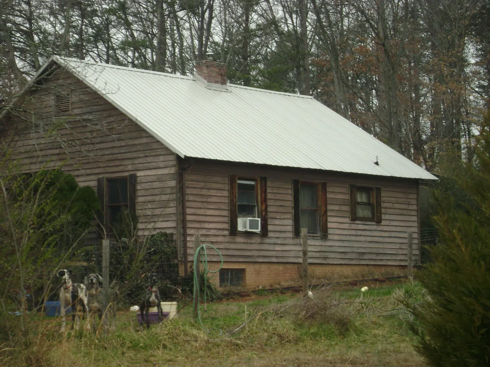 White metal roof on an old wood sided farmhouse, from a Metal Roof Installation job in Gilbertsville